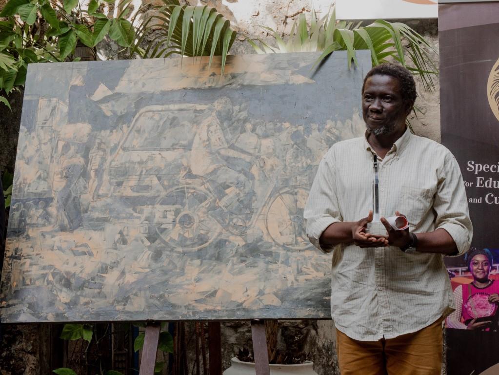 Hamza Ausiy, recipient of the first Emerson Art Award, with his painting Sokoni